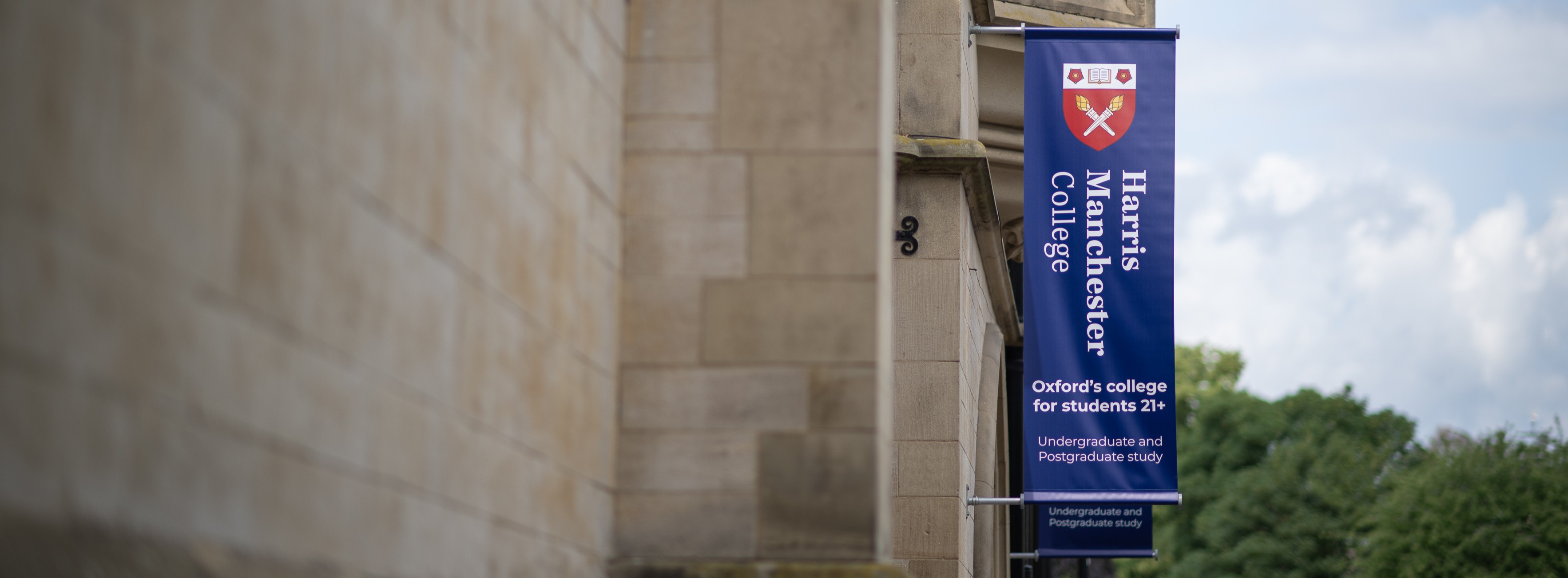Exterior of college with a banner fixed to the wall