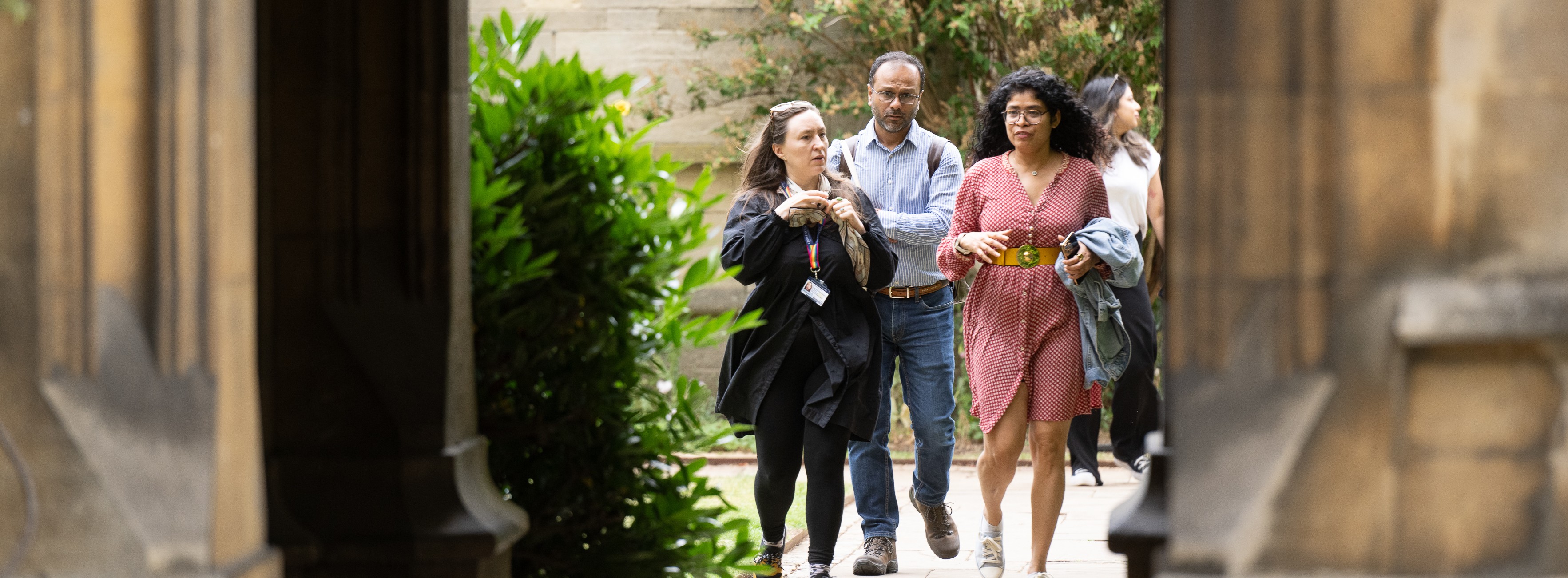 A student guiding a tour around college