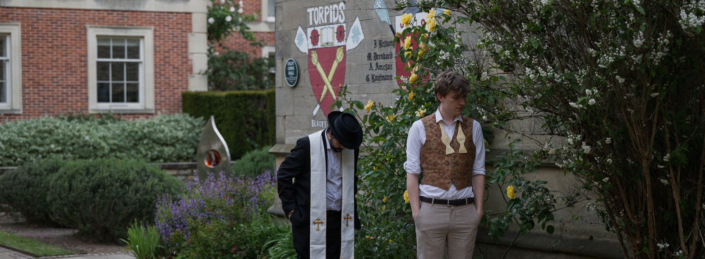 Two student actors dressed in costume in the college quad
