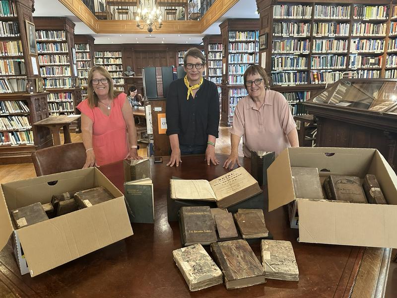 College Librarian Kate Alderson-Smith (centre) with Nans Davies and her sister, Mair Potter, in the Tate Library with the newly acquired books.