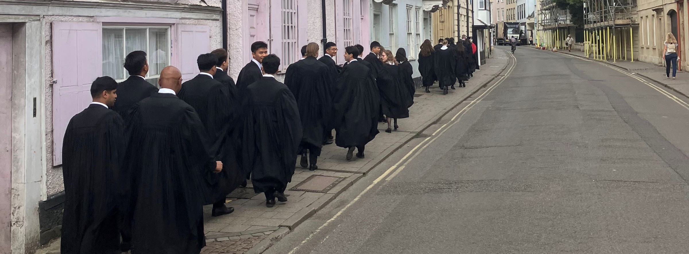 Graduating students in gowns in an Oxford street