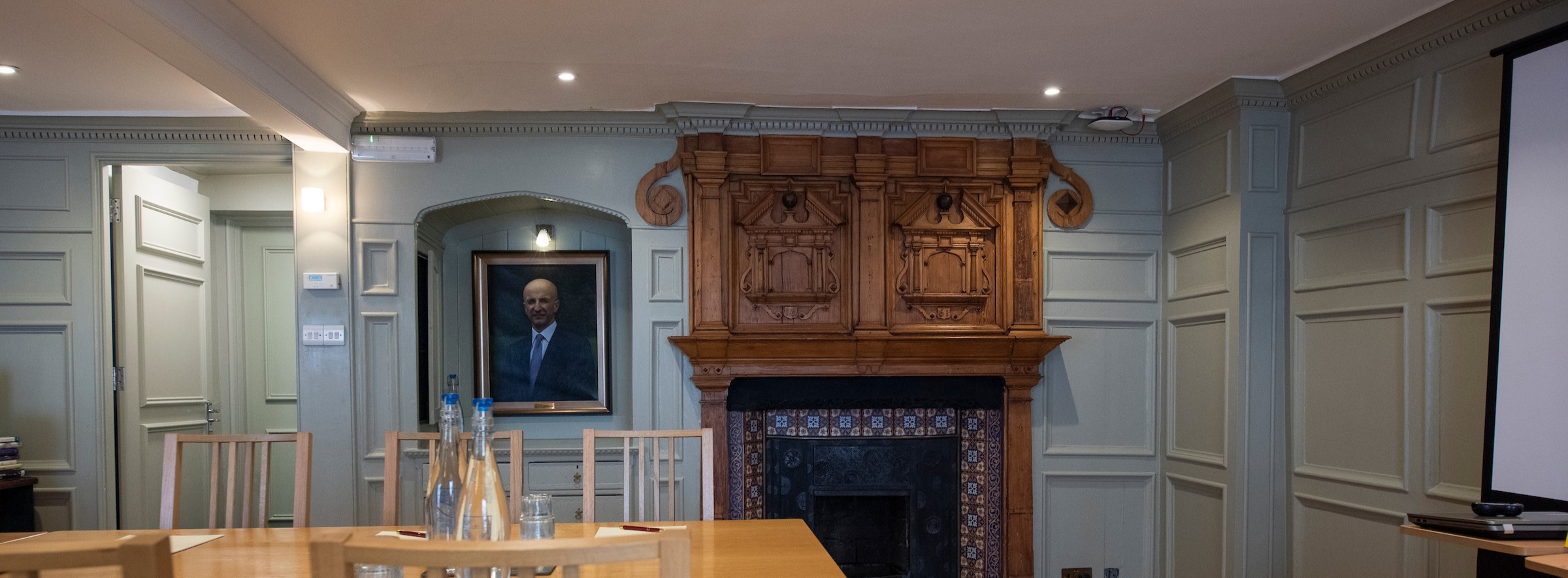 Antique fireplace with conference table in foreground