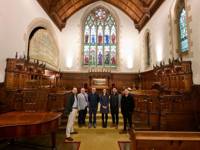 A group of people standing in the HMC Chapel