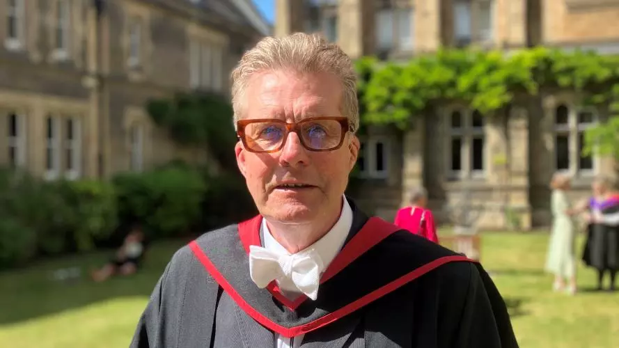 Chris Wheeler in graduation gown