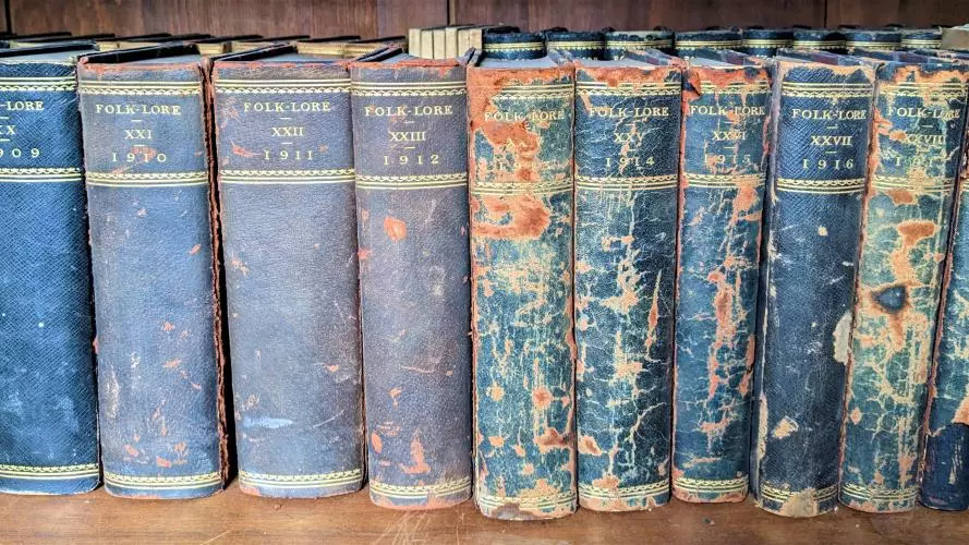 A photograph of a set of journals bearing the name Folklore dating from 1910s