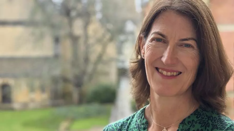 Professor Beth Breeze with background of Harris Manchester College