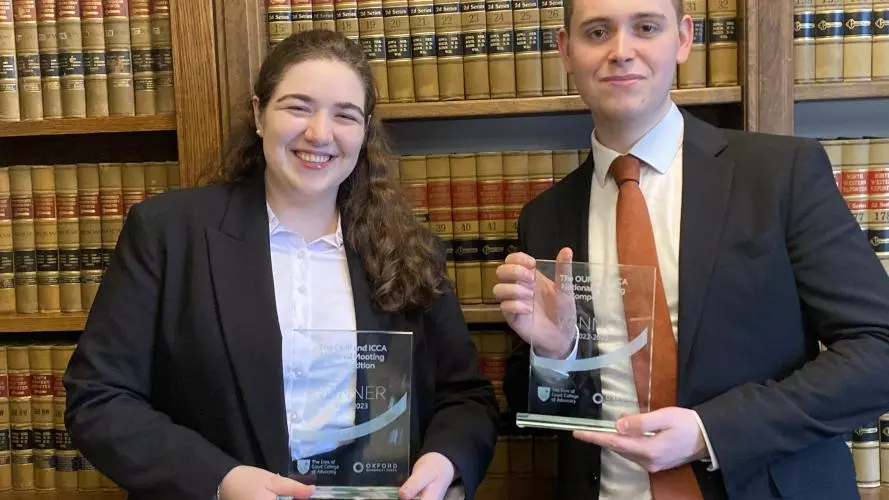 Man and woman holding trophy