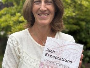 HMC Principal Beth Breeze holding her new book