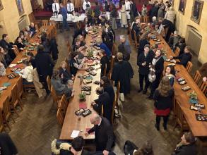 lots of people gathered in hall enjoying Christmas treats 