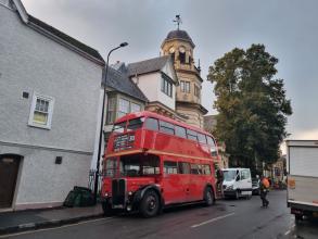 A vintage double-decker bus outside Harris Manchester College