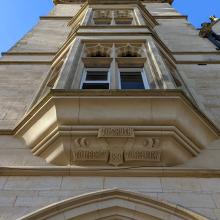 An upward shot of the foundation stone above the main entrance doorway which displays the College motto - To Truth, To Liberty, To Religion