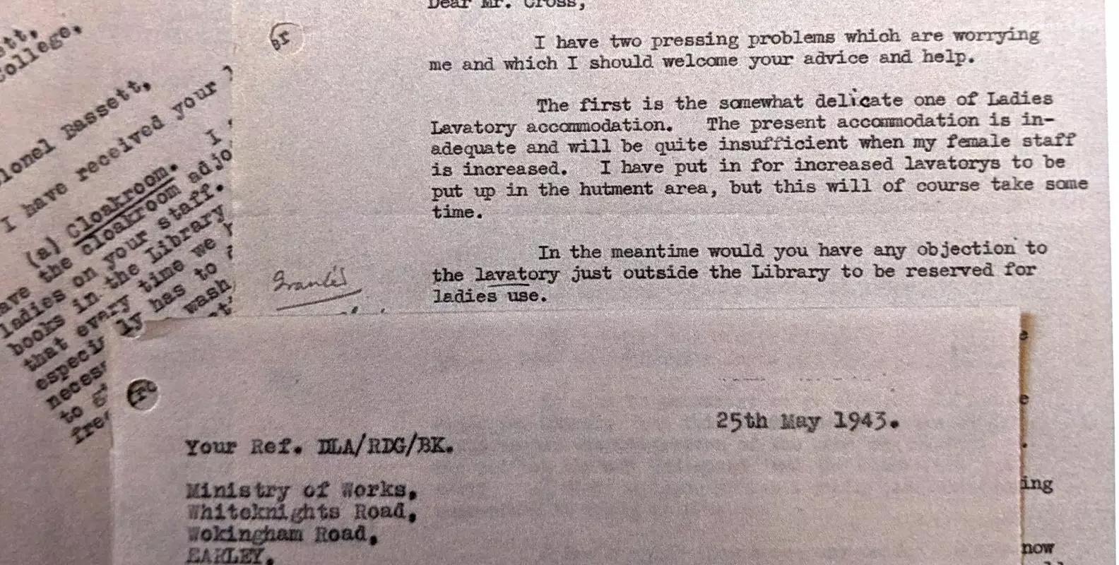 A series of typed letters arranged one on top of the other