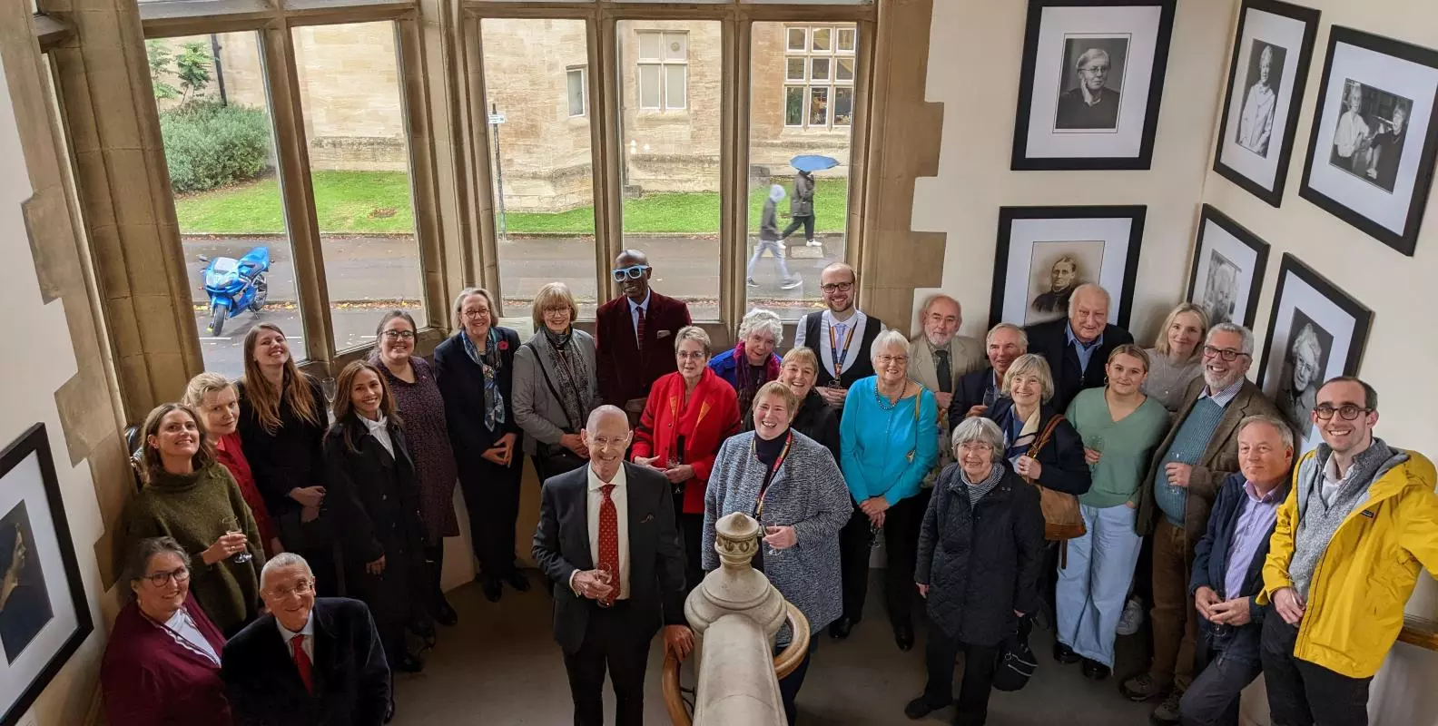 A group shot on the stairs at Harris Manchester College