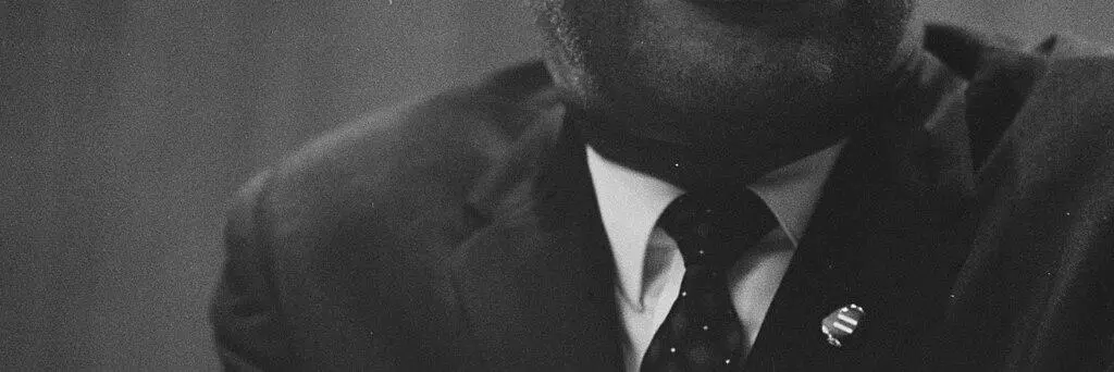 Martin Luther King leaning on a lectern