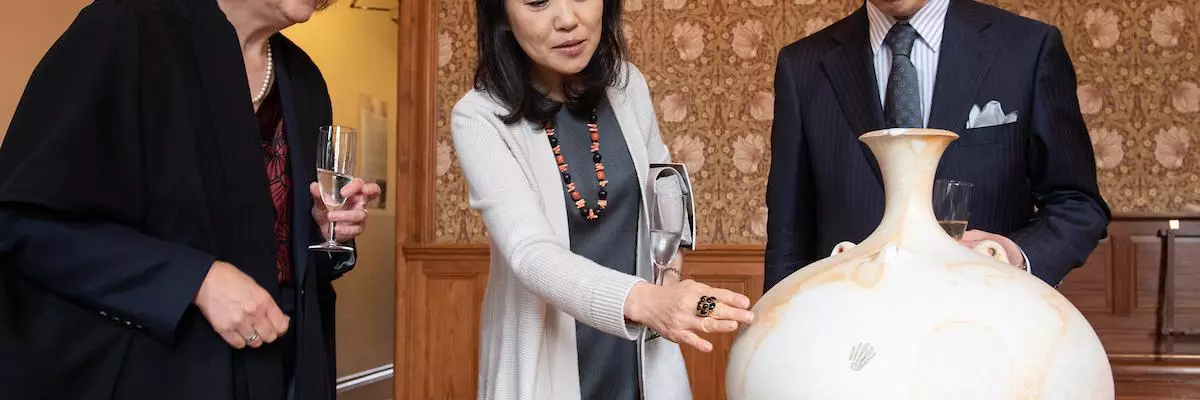 Ambassador and Madamme Hayashi with the Principal admiring Peter Sparrey's stoneware pot.  
