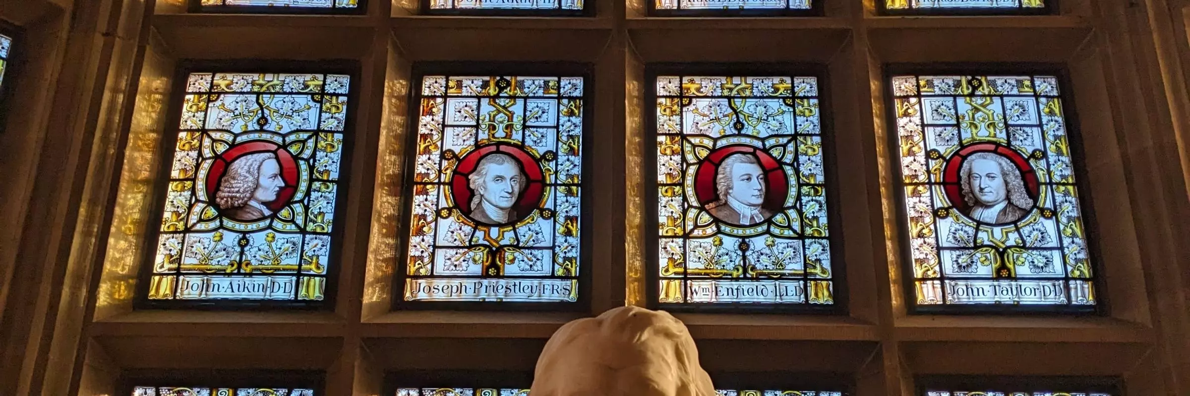 A picture of the Warrington Windows with the martineau statue in the foreground